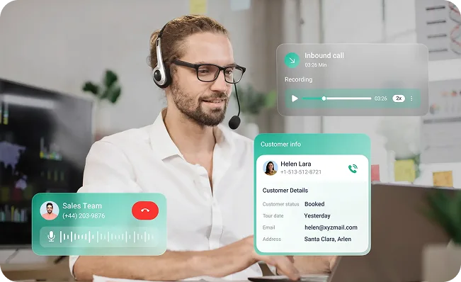 Sales professional on a mobile phone call while reviewing customer details on a laptop